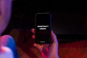 Opportunities for paraplanners and financial advisors Opportunities on phone screen held by human hand